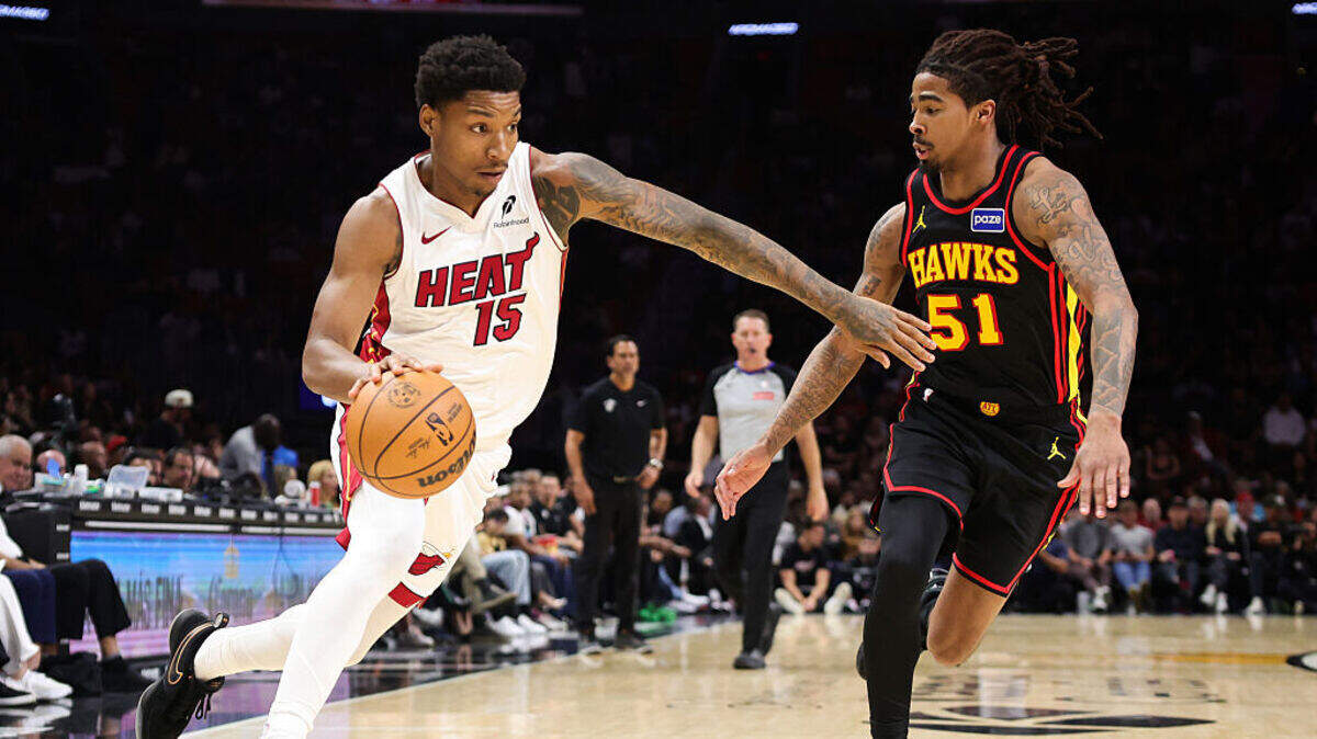 Myron Gardner #15 of the Miami Heat drives against Keshon Gilbert #51 of the Atlanta Hawks during the fourth quarter of the game at Kaseya Center on April 12, 2026 in Miami, Florida.